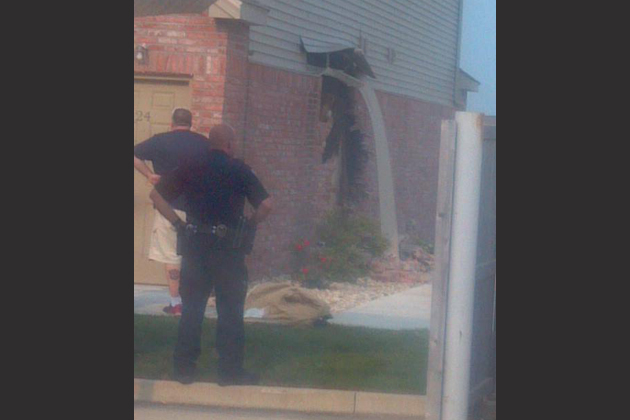 Authorities examine the damage left after a man crashed into an apartment building Sunday. (Photo courtesy Mark Embry)